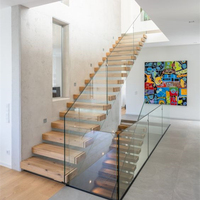 Escalier flottant cantilever d'intérieur avec balustrade en panneaux de verre, support dissimulé et options multiples de marches en bois