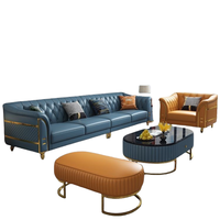 Ensemble de canapés capitonnés en cuir véritable avec ottoman, fauteuil et pieds en métal doré, matelassé, luxe bleu-orange pour salon et villa