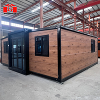 Casa Contenedor Expandible de 20 Pies con Marco Negro, Estilo Madera Granulada, Dos Dormitorios y Un Baño