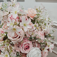 Centres de table floraux élégants roses et blancs sur un support doré, idéaux pour les mariages et événements romantiques.
