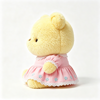 Ours en peluche compact Kawaii avec tenue à volants et imprimé floral, texture douce et bouclée, jouet en peluche animal en peluche