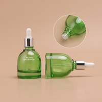 Flacon compte-gouttes rond en verre vert Bravo Industrial avec bouchon pipette en caoutchouc et aluminium argenté pour huiles essentielles et sérum facial