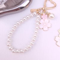 Mode nouveau bicolore fleur alliage porte-clés pendentif mignon petite fleur blanche lettre perle accessoires casque couverture sac pendentif
