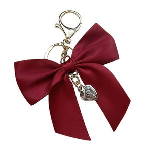 Porte-clés de luxe en alliage de zinc tressé avec ruban et nœud, motif dessin animé, pendentif cœur mignon fait main, doux, chic et tendance, breloque de sac à main - Product Image 3