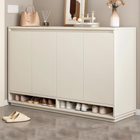 Un meuble à chaussures en bois blanc et gris, élégant et simple, utilisé pour l'entrée, avec une porte et des compartiments cachés