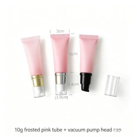Tube souple rose givré de 3 cm de diamètre avec tête de massage en céramique et capuchon pompe à vide pour crème contour des yeux