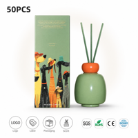 Diffuseur à bâtonnets en céramique 220 ml, bouteille vert sauge émaillée, col décoratif orange, bâtonnets verts, vente en gros sous marque privée