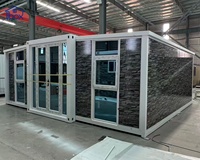 Maison conteneur extensible moderne avec portes vitrées de luxe et extérieur en pierre personnalisé pour usage résidentiel