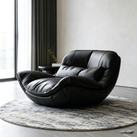 Fauteuil inclinable en cuir noir surdimensionné de style bohème, coque incurvée en fibre de verre, canapé individuel pour un espace intérieur minimaliste