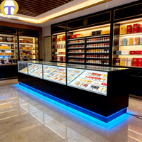 Comptoir d'îlot de vente au détail moderne avec éclairage LED, verre trempé, construction en MDF, robuste et écologique pour les magasins de tabac