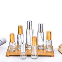 Flacon de sérum en verre transparent de luxe avec pompe distributrice et options d'impression multiples pour les spas, salons de beauté et soins aromathérapeutiques