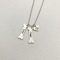 Collier personnalisé en acier inoxydable avec nom de chien et pendentif en forme d'os ou de patte pour animaux de compagnie, idéal pour le dropshipping et comme cadeau