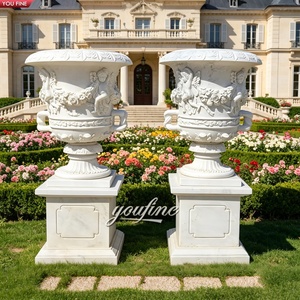 YOUFINE Coppia di Urne Decorative in Marmo Bianco Naturale con Rilievo di Cherubini e Fiori, Vaso in Pietra Intagliata a Rosa con Piedistallo Quadrato per Giardino e Villa - Product Image 1