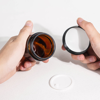 Bocaux en verre en gros avec bouchon à vis 50ml 60ml 100ml, capuchon noir, surface givrée, impression soyeuse pour crème de soin et blush