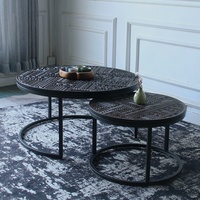 Table basse vintage en teck massif nordique belge sculpté avec structure métallique, design simple et rond, pour salon