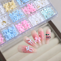 24 compartiments de décorations pour nail art : nœuds en ruban de résine, mélange de perles, ours, fleurs, strass, ornements en alliage, cerises et autres fournitures pour ongles