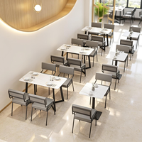 Moderne minimalistische commerciële cafétafel met metalen poten en comfortabele PU lederen stoelenset voor koffieshop en fastfood
