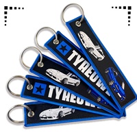 Porte-clés promotionnels personnalisés en tissu brodé de haute qualité avec étiquette tissée, porte-clés brodé personnalisé en forme de jet tag
