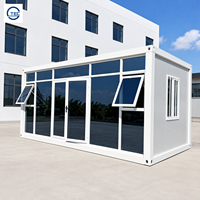 Maison préfabriquée modulaire en conteneur à ossature métallique, à un étage, avec mur entièrement vitré et porte double vitrée, pour bureau ou salle d'exposition
