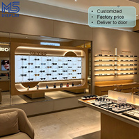 Vitrine d'exposition personnalisée pour magasin d'optique, présentoir mural en bois rétroéclairé par LED pour lunettes, étagère de vente au détail pour lunettes de soleil, pour magasin d'optique, centre commercial, kiosque