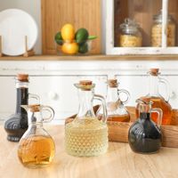 Bouteilles en verre transparentes en stock, design moderne et minimaliste, poignée sculptée en forme de fleur pour cuisine ; bidon à huile, bouteille de vin