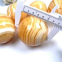 Grosir batu penyembuhan kualitas tinggi dipoles alami oranye bola kalsit untuk dekorasi Fengshui