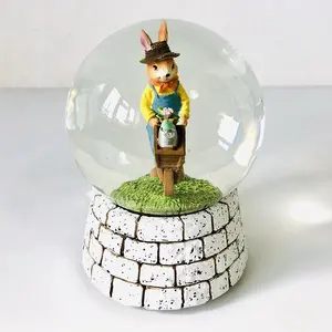 Bonito globo de nieve de cristal de resina de conejo exquisito muñeco de nieve hecho a mano y figurita de conejo para decoración del hogar y regalos de recuerdo