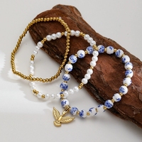 Bijoux délicats en acier inoxydable plaqué or 18 carats chaîne perlée perles en céramique perle Pigeon breloques couche bracelet pour femmes