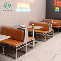 Nouveauté Ensemble table et chaises moderne en acier inoxydable en cuir acrylique pour café commercial et restaurant Meuble de cabine