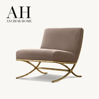 Fauteuil d'appoint moderne de luxe en velours taupe, sans accoudoirs, avec base en X texturée bronze, fauteuil lounge minimaliste pour salon et mobilier d'hôtel