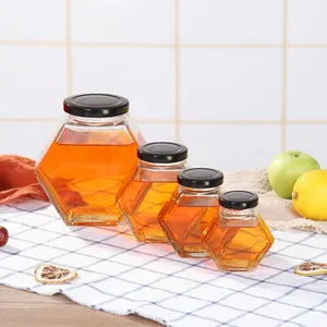 Pots en verre hexagonaux clairs de qualité alimentaire vides transparents en forme de nid d'abeille 100ml pour miel avec couvercles en métal