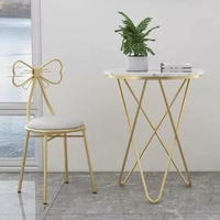 Chaise de coiffeuse rose à dossier nœud avec structure en métal doré pour salon OEM