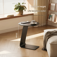 Table basse ronde moderne avec plateau en métal et structure en acier, design minimaliste mobile pour salon et salle à manger