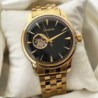 Montre automatique rétro à cadran noir brillant effet rayons de soleil, mouvement apparent, bracelet en acier inoxydable doré pour homme