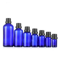Vente en gros de flacons cylindriques en verre bleu anti-UV pour huiles essentielles, surface givrée, pipette compte-gouttes noire, col 18-415, personnalisable