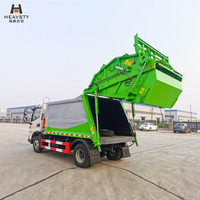 Camion compacteur de déchets HEAVSTY 7 mètres cubes 4x2 à transmission manuelle et chargement arrière, moteur et boîte de vitesses pour bacs de 120L/240L