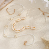 Parure de bijoux bohèmes pour femme avec coquillages, étoiles de mer et perles – Collier superposé, boucles d'oreilles et bracelet