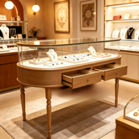 Comptoir de présentation de bijoux ovale, vitrine à bijoux en verre avec éclairage LED et tiroirs de rangement, mobilier sur mesure pour magasin de bijoux de luxe
