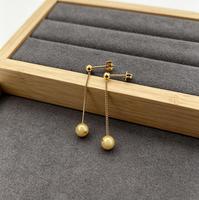 Boucles d'oreilles pendantes hypoallergéniques en acier inoxydable plaqué or 18 carats avec chaîne longue et pompon pour femme, idéales pour le quotidien et les soirées