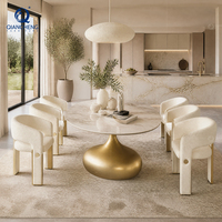 Table à manger ovale en pierre frittée avec base dorée trompette, ensemble de 6 chaises bouclées, luxe discret pour villa et hôtel, vente en gros, usine OEM