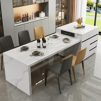 Table de salle à manger îlot en dalle de pierre moderne et minimaliste, intégrée, extensible, avec comptoir de bar et rangement, pour séparation de salon et cuisine, au design épuré