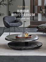 Table basse rotative à double niveau en acier inoxydable, design italien, style minimaliste et artistique, pour salon de luxe.
