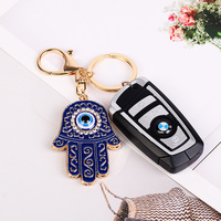 Porte-clés main Hamsa en émail à la mode exquis avec porte-clés de décoration de sac en alliage incrusté de strass de conception du mauvais œil