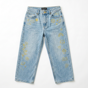 Bulk manufacturing service for light blue, wide-leg women's jeans with yellow embroidered patterns. - Product Image 1