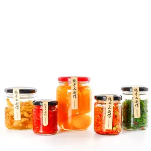 Frascos de almacenamiento de vidrio redondo de 50ml-1000ml a precio de fábrica para mermelada de pepinillo de miel con tapa de metal