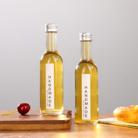 Bouteille en verre mini haute transparence de 50 ml et 100 ml avec étiquette personnalisée et bouchon en aluminium, conçue pour la bière, le brandy, les boissons énergisantes et le vin