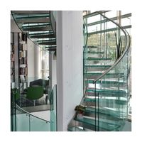 Escalier incurvé moderne de luxe avec main courante en verre et éclairage LED pour les maisons contemporaines Escaliers incurvés
