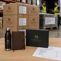Ensemble cadeau d'entreprise personnalisé avec logo, comprenant une bouteille gravée, un carnet en cuir, un stylo en métal et un coffret cadeau haut de gamme