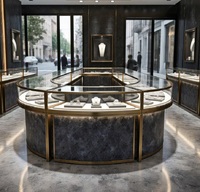 Comptoir de présentation de bijoux circulaire haut de gamme sur mesure en marbre foncé, métal doré, verre trempé, éclairage LED - Vitrine de luxe durable