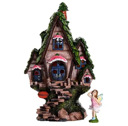 Resin fairy girl and garden statue of Christmas house with lights